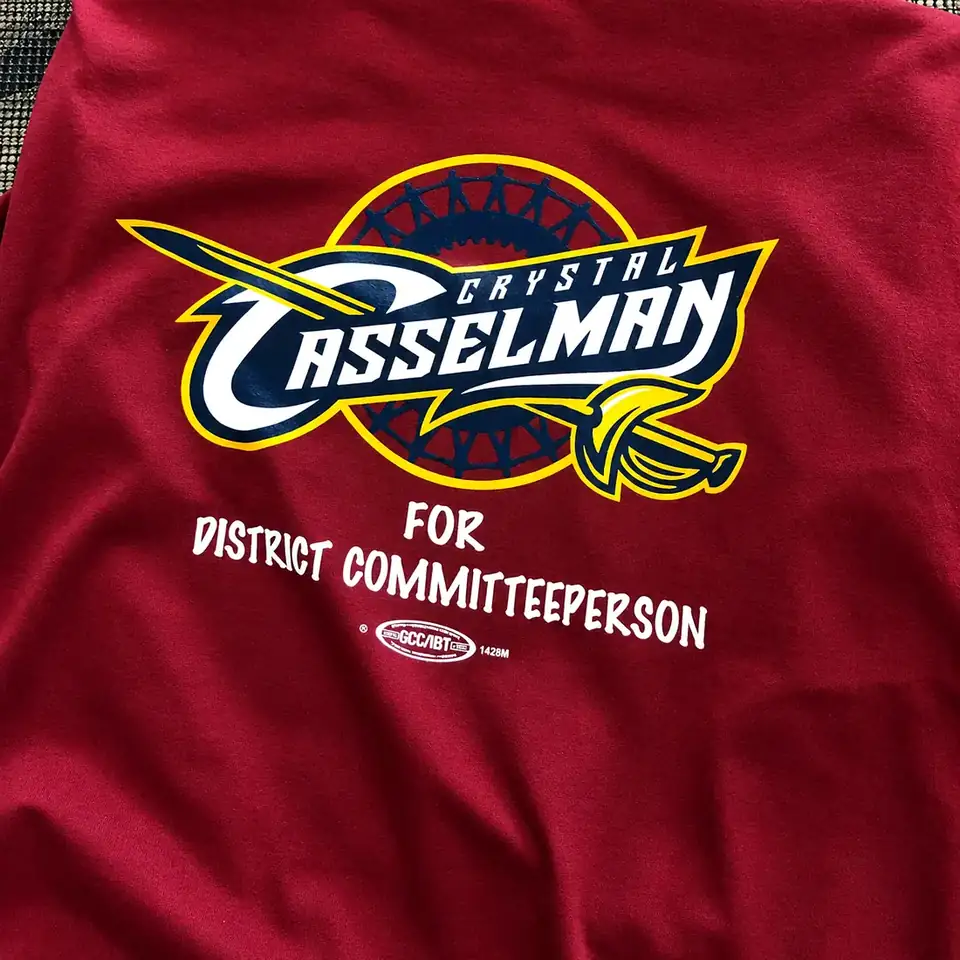Maroon campaign T-shirt with a multi-colour logo and a union print label