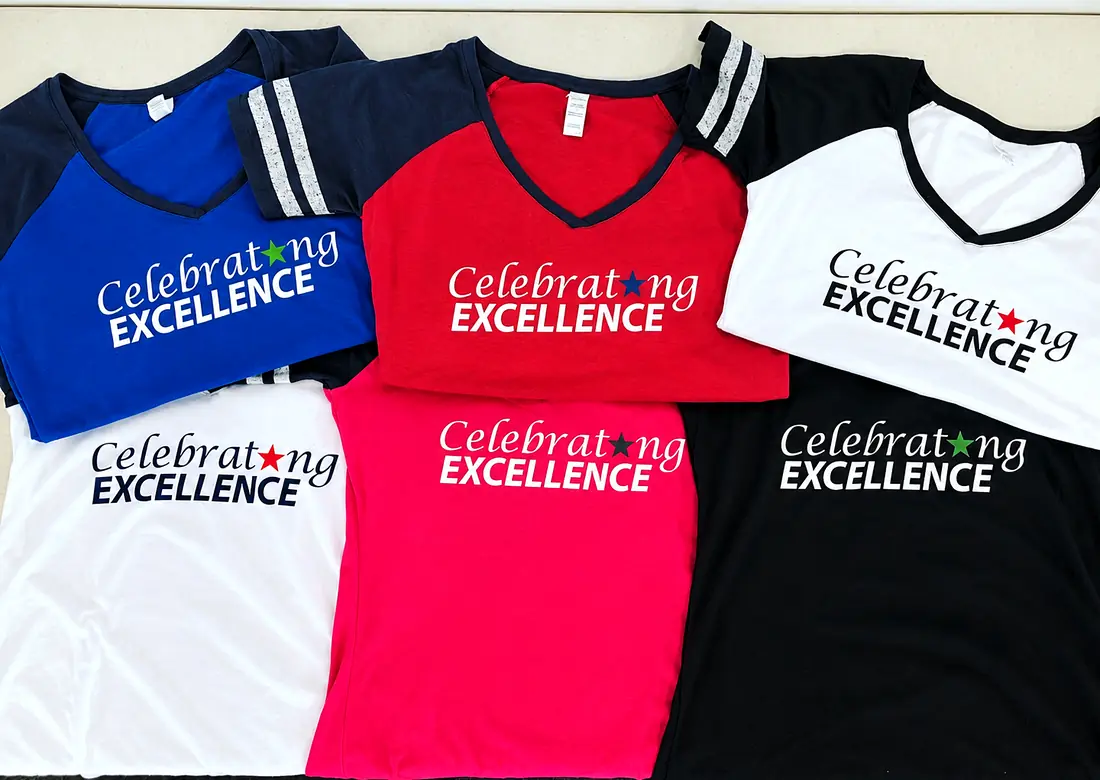 Six shirts in different colours, each printed with Celebrating Excellence